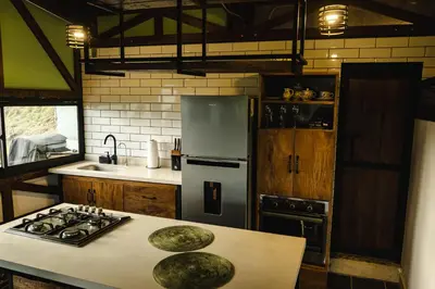 a kitchen with a stainless steel refrigerator and a counter at Refined cabin, panoramic views, steps from Jericó in Jericó