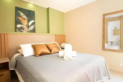 a bedroom with a bed with a mirror at ApartaSuite moderno. Gran Vista. in Medellín