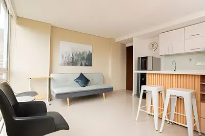 a living room with a couch and two stools at ApartaSuite moderno. Gran Vista. in Medellín
