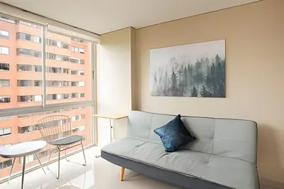 a living room with a couch and a table at ApartaSuite moderno. Gran Vista. in Medellín