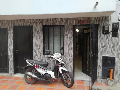 a motorcycle parked in front of a building at Hospedaje J&L in Medellín