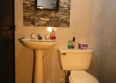 a bathroom with a sink and a toilet at Hospedaje J&L in Medellín