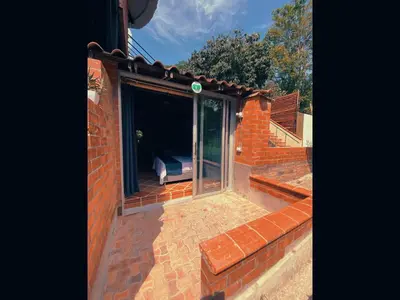 a room with a glass door on a brick building at Eco Hotel El Acuario in San Jerónimo