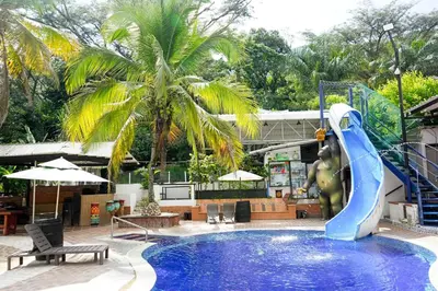 a swimming pool with a blue water slide at Eco Hotel El Acuario in San Jerónimo