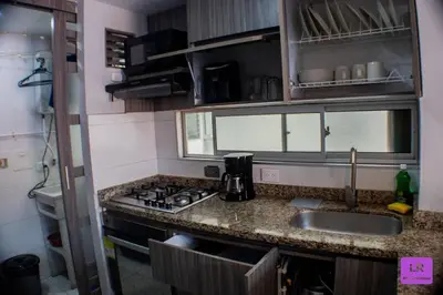 a small kitchen with a sink and a stove at Apartamento Lujoso y Nuevo en Milán in Manizales