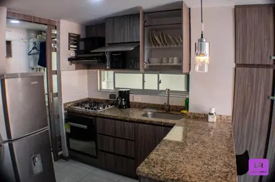 a kitchen with a sink and a refrigerator at Apartamento Lujoso y Nuevo en Milán in Manizales