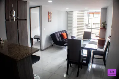 a kitchen and dining room with a table and chairs at Apartamento Lujoso y Nuevo en Milán in Manizales