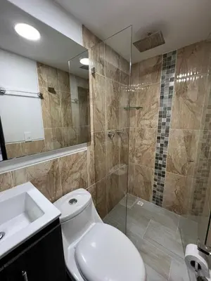 a bathroom with a toilet and a shower and a sink at Hotel Casa Florida 70 Medellin in Medellín
