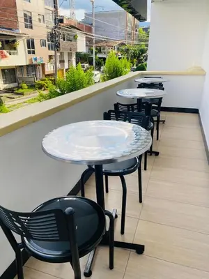 a row of tables and chairs on a balcony at Hotel Casa Florida 70 Medellin in Medellín