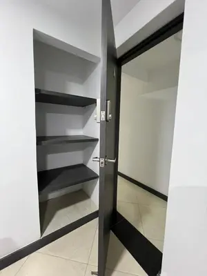 a walk in closet with black shelves and a door at Hotel Casa Florida 70 Medellin in Medellín