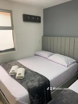 two beds sitting next to each other in a bedroom at Hotel Casa Florida 70 Medellin in Medellín