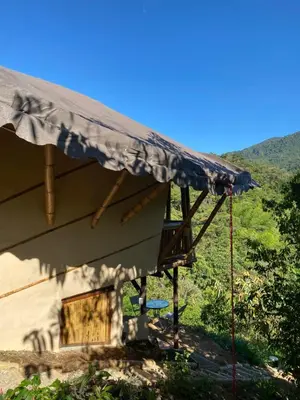 a house with a tarp on the side of it at Macuá, Refugio del bosque in San Rafael