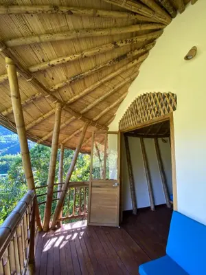 a porch of a house with a wooden ceiling at Macuá, Refugio del bosque in San Rafael