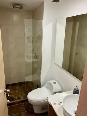 a bathroom with a toilet and a shower and a sink at San Peter Aparta Suite en La 70 Laureles in Medellín