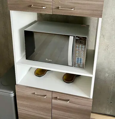 a microwave oven sitting inside of a cabinet at San Peter Aparta Suite en La 70 Laureles in Medellín