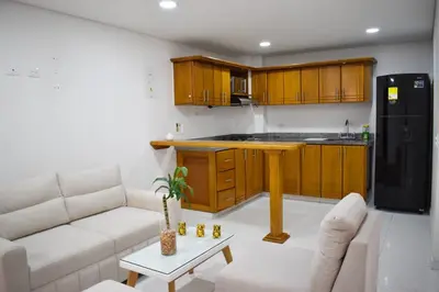 a living room with a couch and a kitchen at Cómodo apartament tipo loft en El Peñol in El Peñol