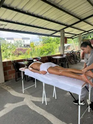 a woman laying on a mattress on a table at Maracuya Hostel in San Rafael