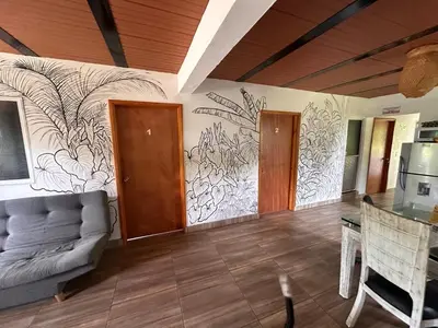 a living room with a mural on the wall at Maracuya Hostel in San Rafael