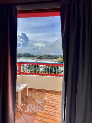a view from a window of a balcony with a table at apartamento duplex con balcon y vista a la represa in Guatapé