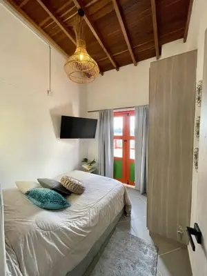 a bedroom with a bed with two pillows on it at apartamento duplex con balcon y vista a la represa in Guatapé