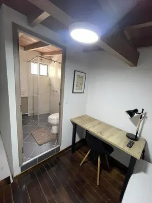 a bathroom with a desk and a shower with a toilet at apartamento duplex con balcon y vista a la represa in Guatapé