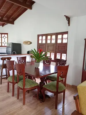 a dining room with a wooden table and chairs at Hermosa Villa La Laja Rionegro in Rionegro