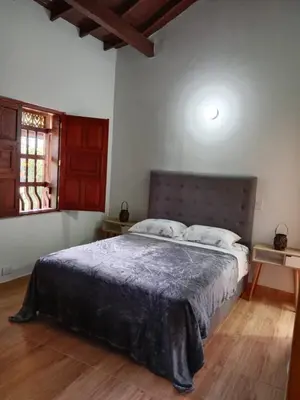 a bedroom with a large bed in a room at Hermosa Villa La Laja Rionegro in Rionegro