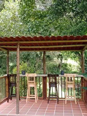 two chairs sitting under a gazebo on a deck at Hermosa Villa La Laja Rionegro in Rionegro