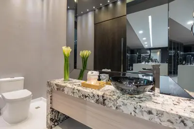 a bathroom with a sink and a toilet at Europa Suites Medellin in Medellín