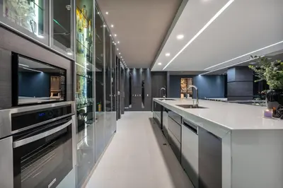 a kitchen with a sink and a dishwasher at Europa Suites Medellin in Medellín