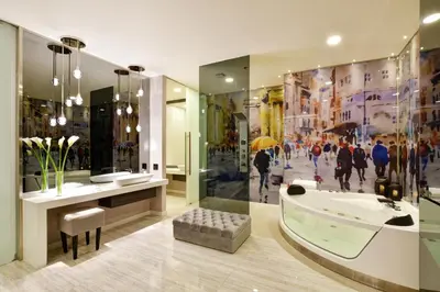 a bathroom with a bath tub and a large window at Europa Suites Medellin in Medellín