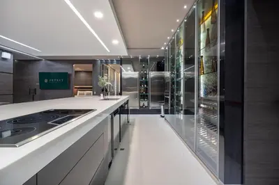 a large kitchen with a counter and a refrigerator at Europa Suites Medellin in Medellín