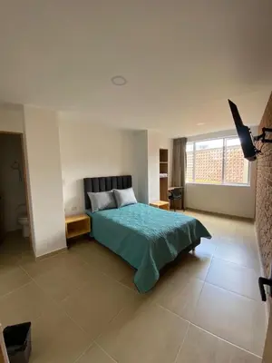 a bedroom with a bed and a large window at BISÁU Hotel in Ruiosucio
