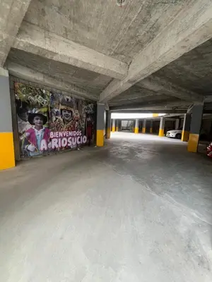 an empty parking garage with graffiti on the walls at BISÁU Hotel in Ruiosucio