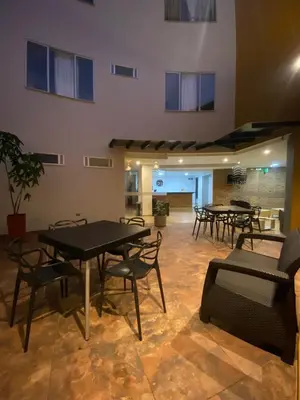 a group of tables and chairs in a room at BISÁU Hotel in Ruiosucio