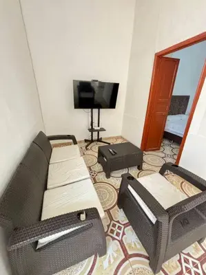 a living room with a couch and a flat screen tv at Casa colonial - Jacuzzi - cerca al parque principal - lundry - Tv in Santa Fe de Antioquia