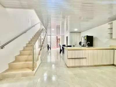 a hallway with a staircase in a house at Casa colonial - Jacuzzi - cerca al parque principal - lundry - Tv in Santa Fe de Antioquia