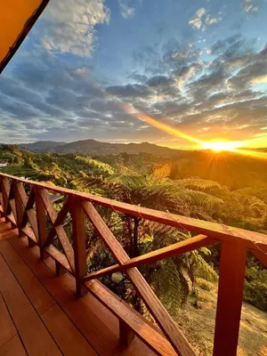 a view of the sunset from a deck at Eco Lodge Glamping in Guatapé
