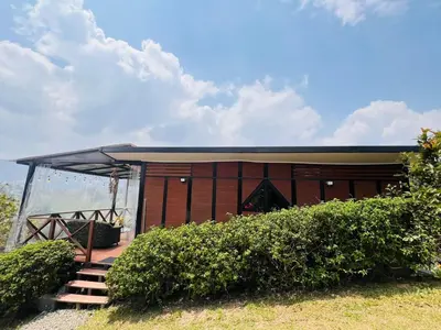 a brown building with a staircase in front of it at Eco Lodge Glamping in Guatapé