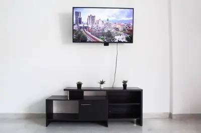 a black dresser in a room with a tv on a wall at Apartamento zona rosa El poblado 202 in Medellín