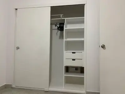 a white closet with two drawers and a microwave at Apartamento zona rosa El poblado 202 in Medellín