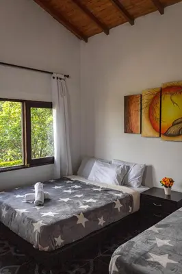 a bedroom with a bed and a window at EDYMA Cabaña con JACUZZI in Guatapé