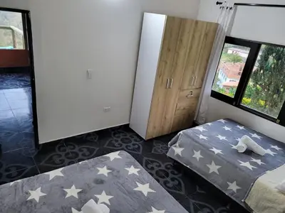 a bedroom with two beds and a closet with stars at EDYMA Cabaña con JACUZZI in Guatapé