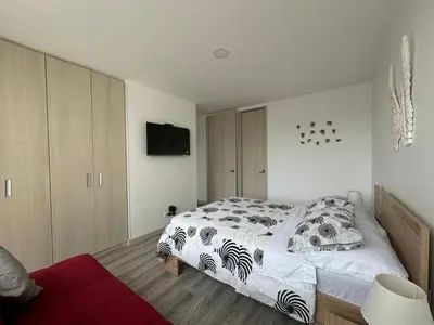 a bedroom with a bed and a television in it at Barcelona in Manizales