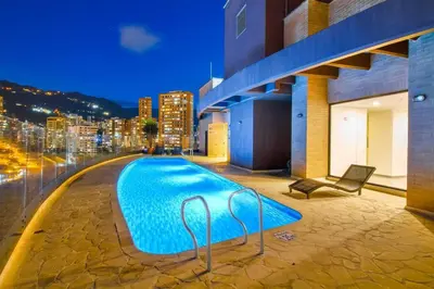 a swimming pool on top of a building with a city skyline at The place you need in Poblado-Medellin 1103 in Medellín