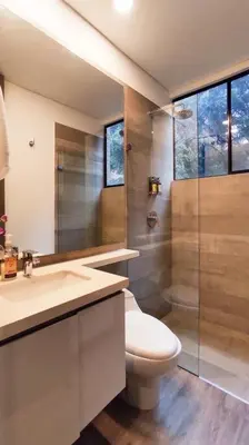 a bathroom with a toilet and a sink and a shower at Ideal place in el Poblado, Medellin in Medellín