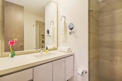 a white bathroom with a sink and a shower at Ideal place in el Poblado, Medellin in Medellín