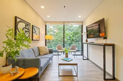 a living room with a couch and a table at Ideal place in el Poblado, Medellin in Medellín