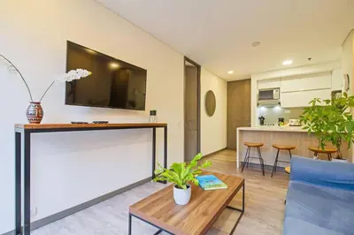 a living room with a tv on a wall at Ideal place in el Poblado, Medellin in Medellín