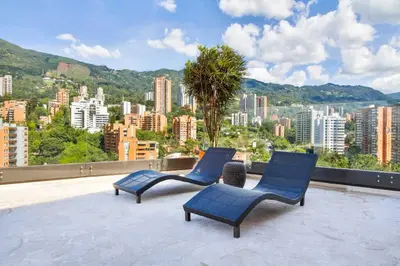 two blue chairs sitting on top of a roof at The perfect stay in Medellín - 904 in Medellín